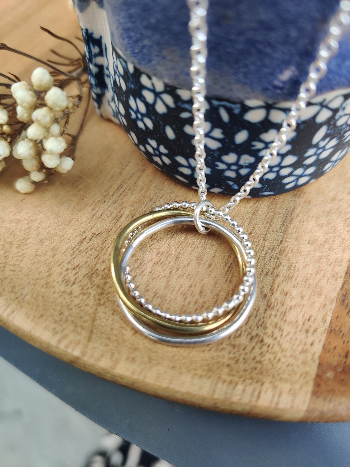 Twisted hoops pendant, silver and brass