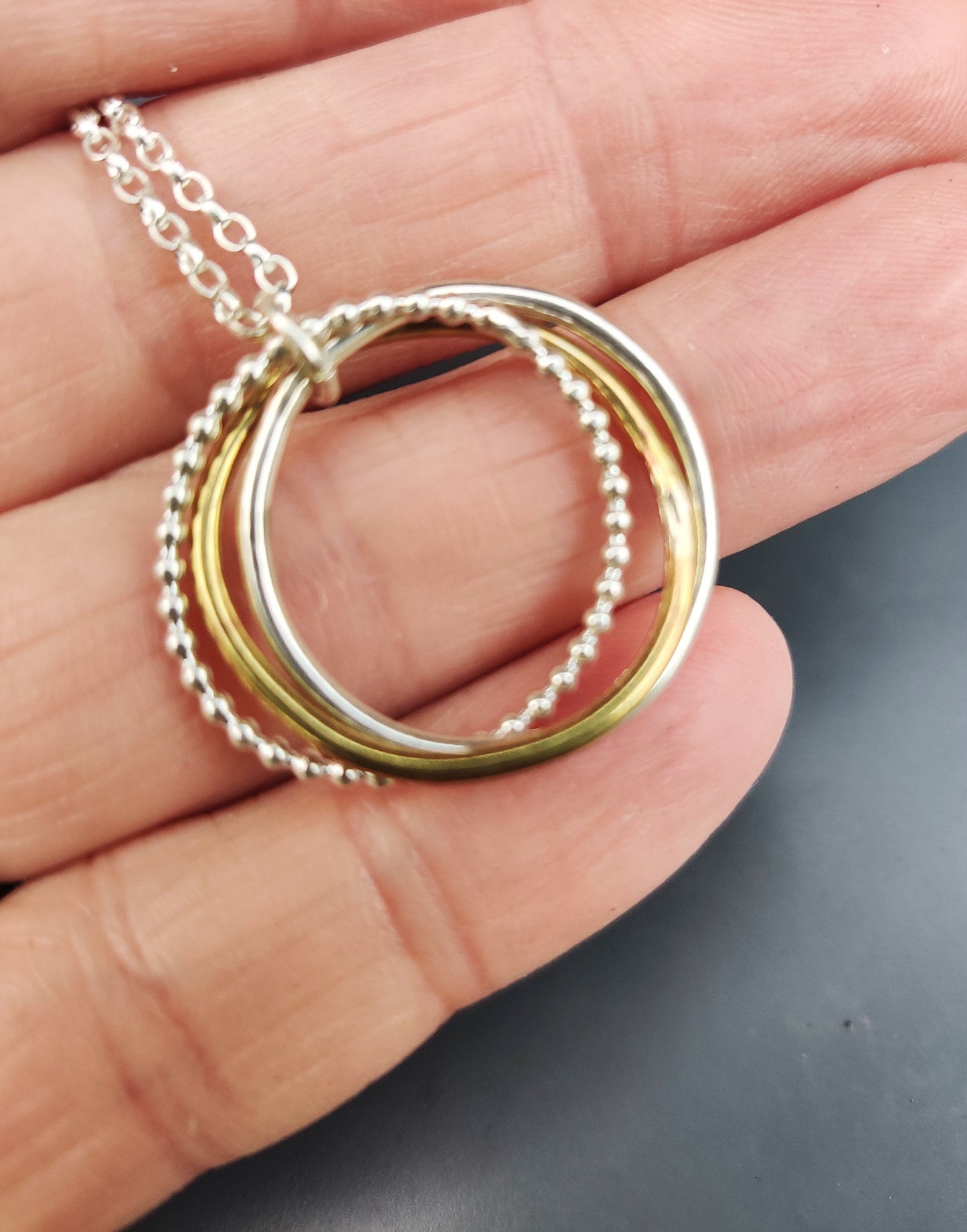 Twisted hoops pendant, silver and brass