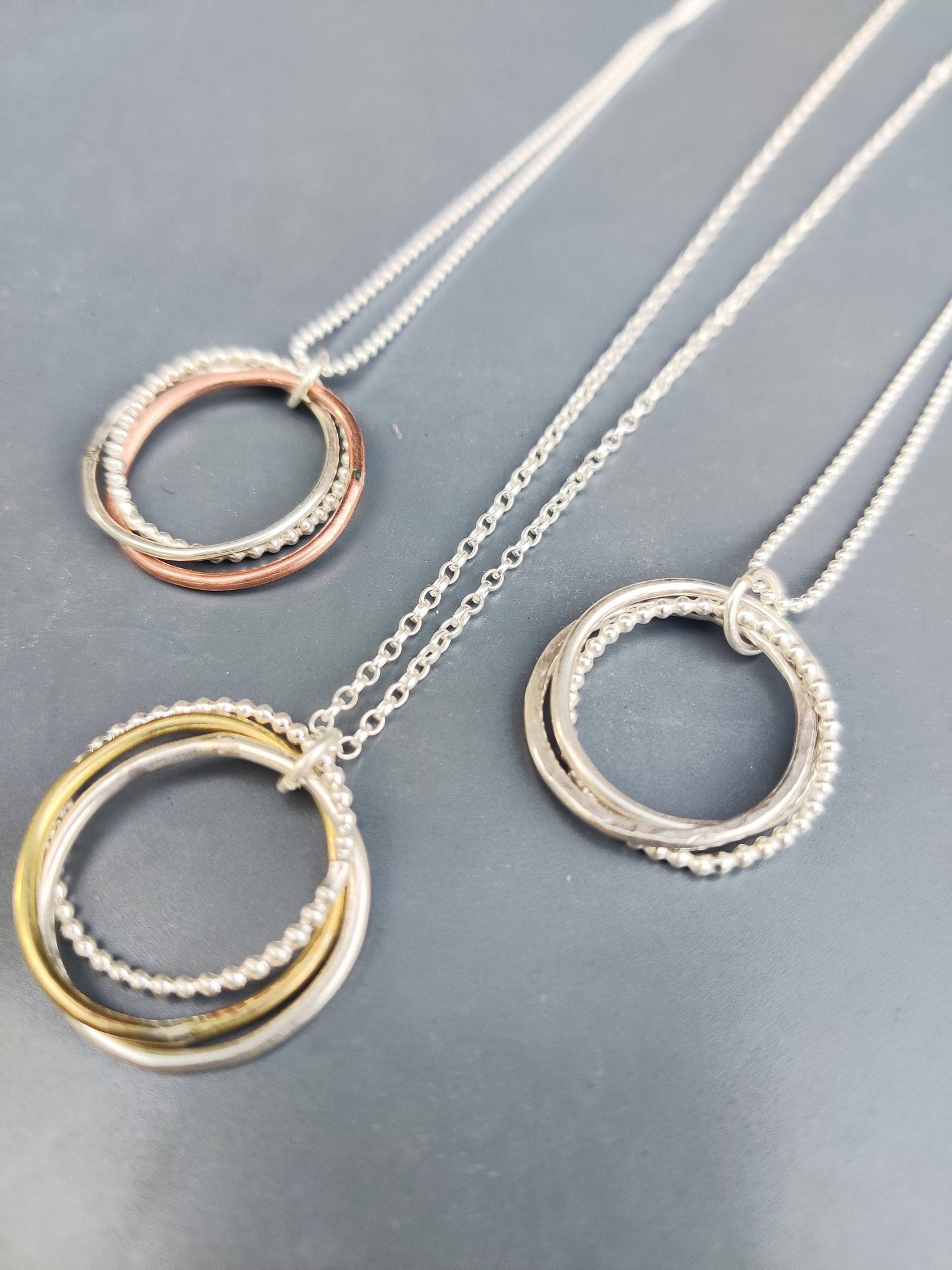 Twisted hoops pendant, silver and brass