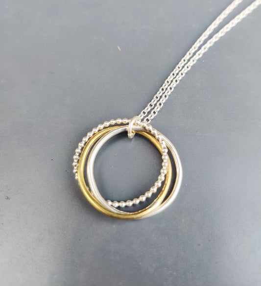 Twisted hoops pendant, silver and brass