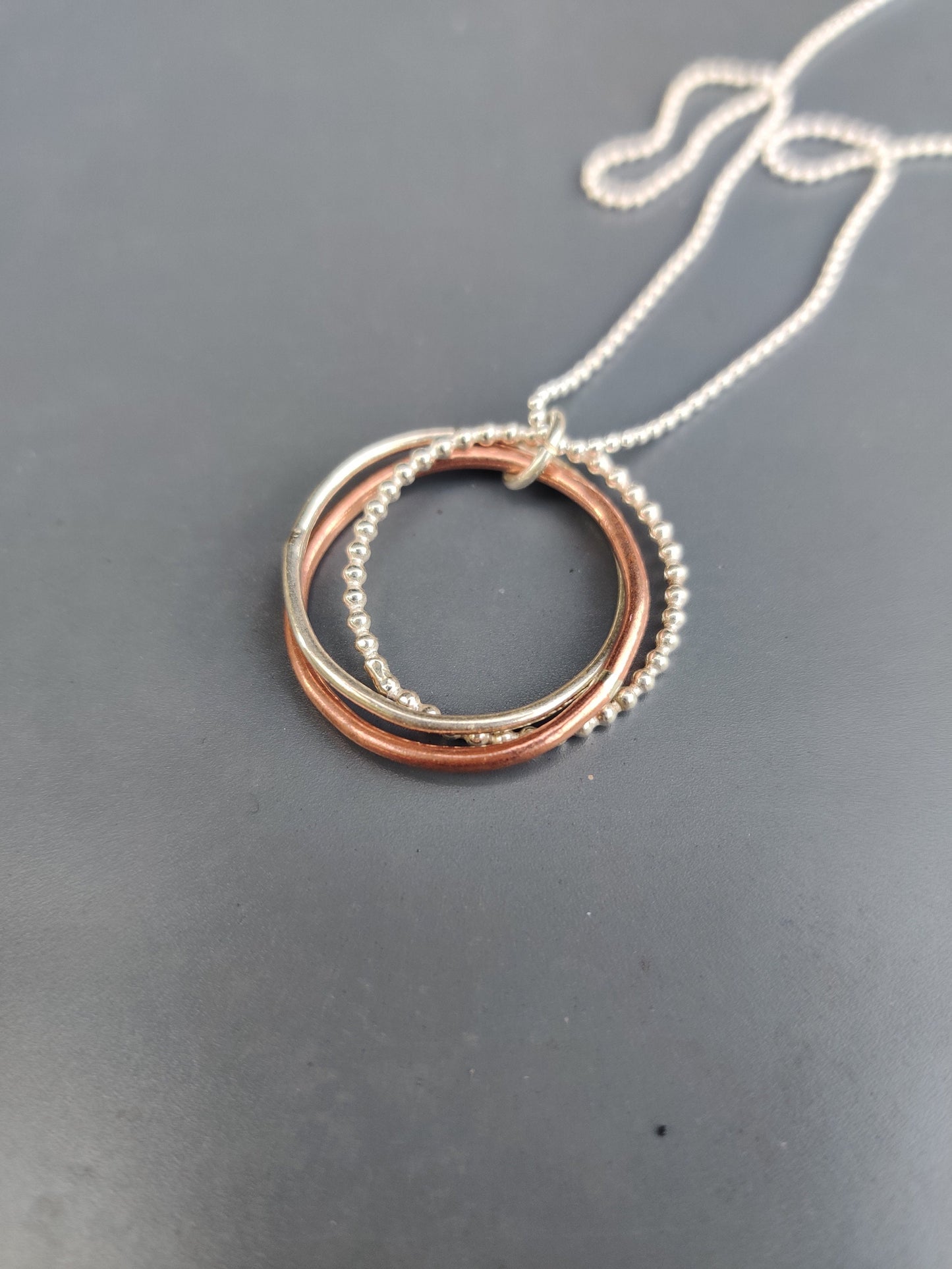 Twisted hoops pendant, silver and copper